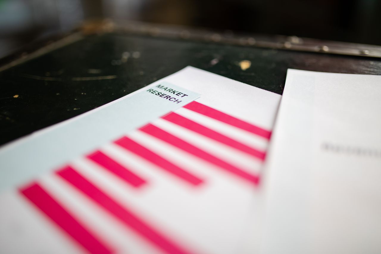 who-we-are A detailed close-up of a market research document featuring a bar graph and a focus on market trends.